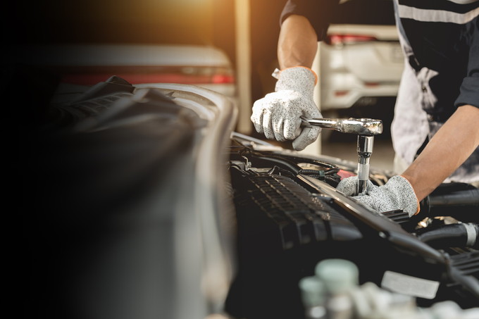 Automobile mechanic repairman hands repairing a car engine autom Automobile mechanic repairman hands repairing a car engine automotive workshop with a wrench, car service and maintenance,Repair service.